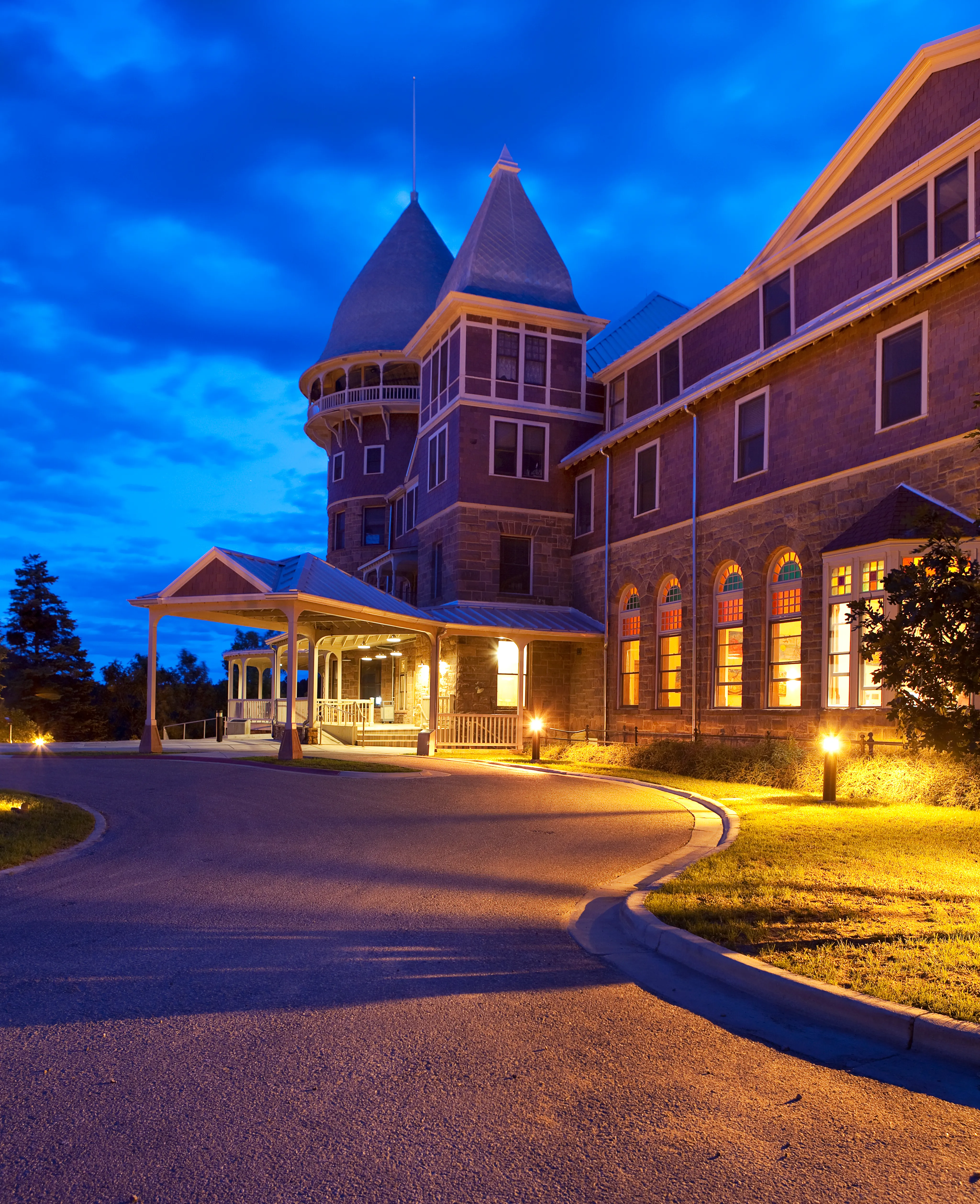 The UWC USA school building is illuminated by warm light at light